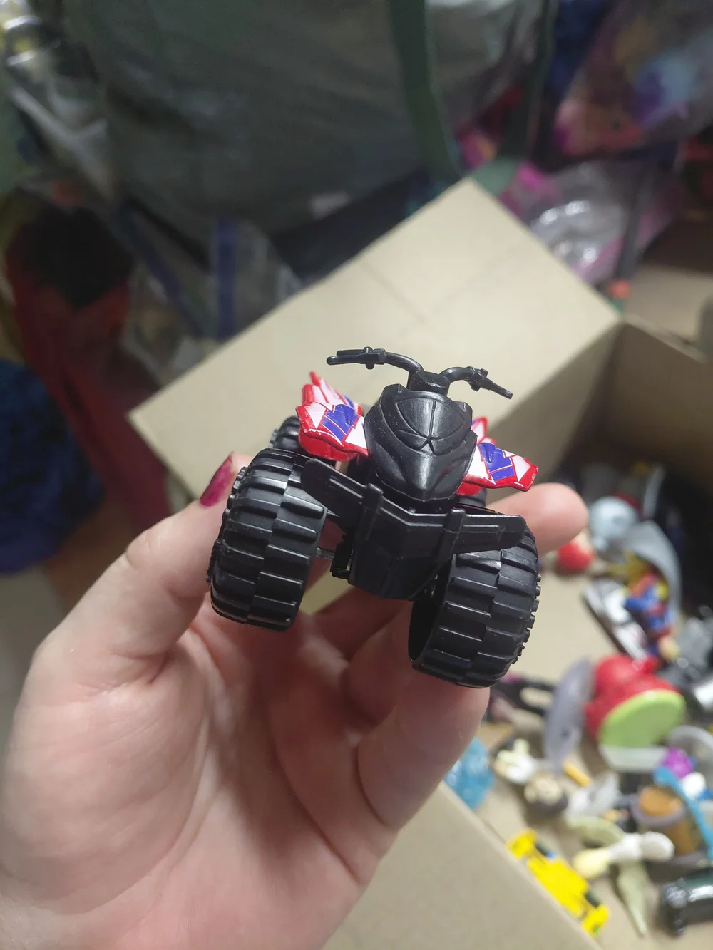 a Greenbrier International EX500 3-inch die-cast red quad ATV toy,